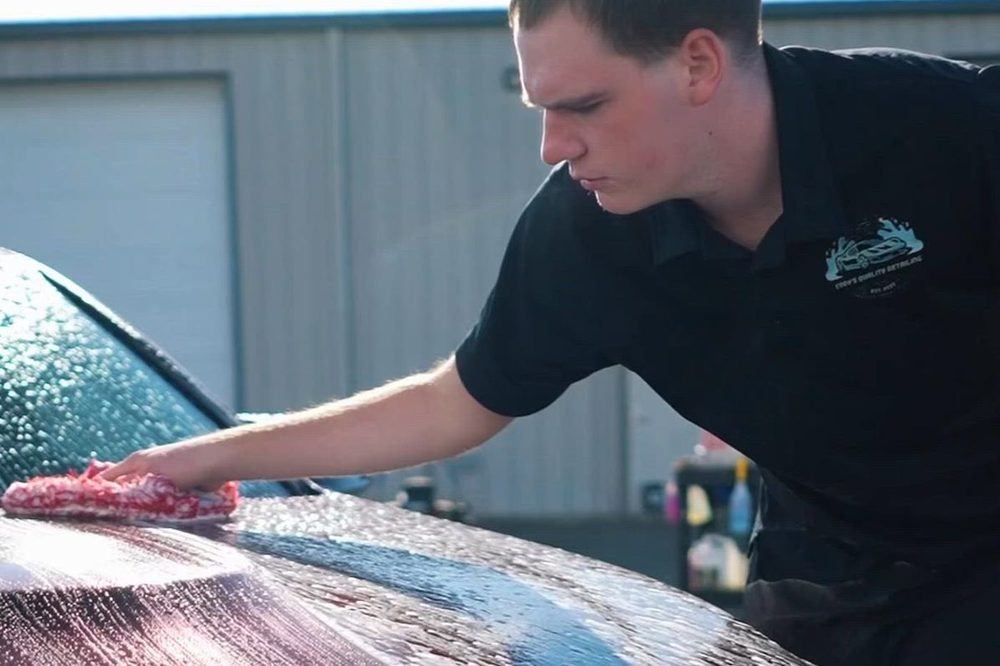 Cody hand-washing a black BMW